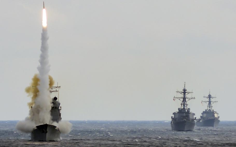 In a March, 2016 file photo, the guided-missile cruiser USS Monterey launches a Standard Missile-2 to destroy an advanced high-speed target while USS Stout and USS Mason transit formation during a live-fire test of the ship's Aegis weapons systems in the Atlantic Ocean. The Aegis system is credited with helping stop an attack on the Mason on Oct. 12, 2016 off Yemen.