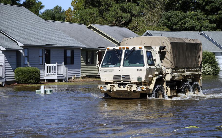 A National Guard vehicle drives through flood waters on Wednesday, Oct. 12, 2016 at the Wyndham Circle duplex complex in Greenville, N.C. 