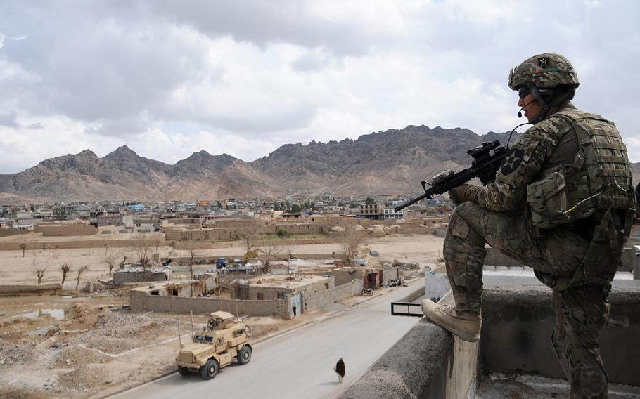 In a 2013 file photo, a security force platoon leader for Provincial Reconstruction Team Farah provides rooftop security during a key leader engagement in Farah City, Afghanistan.
