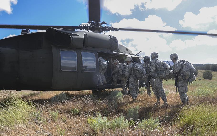 National Guard soldiers board a UH-60 Blackhawk during a training event at Camp Williams, Utah, on June 18, 2014.