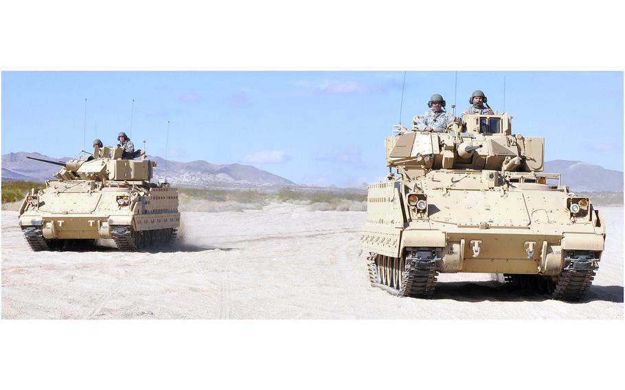 National Guard soldiers maneuver in a "wedge formation" in Bradley Fighting Vehicles at Fort Irwin National Training Center, Calif., on Nov. 5, 2011.