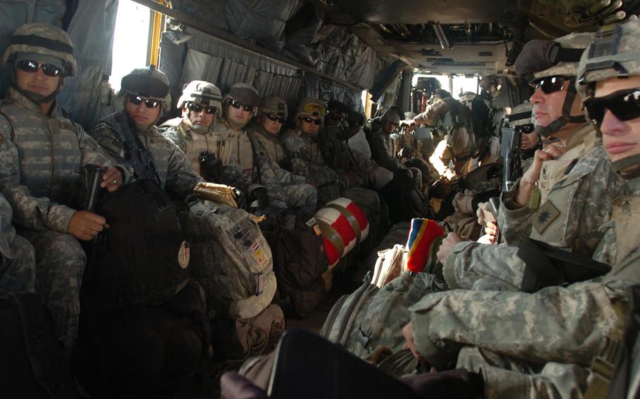 California National Guard soldiers take a last look at Iraq while flying out of the country on a Navy MH-53E "Black Stallion" helicopter on Dec. 14, 2006.