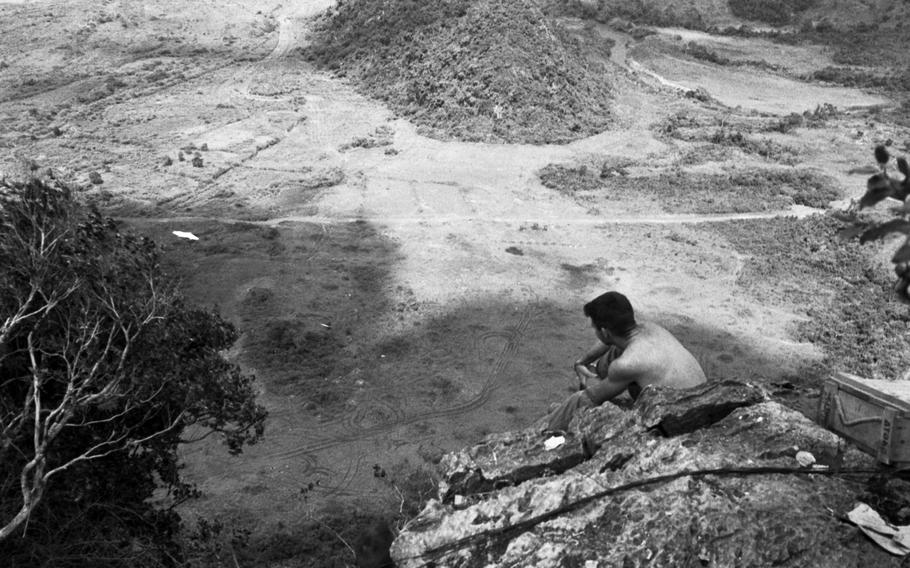 An unknown Marine looks out over a valley from his vantage point atop the Rockpile in November 1966. 