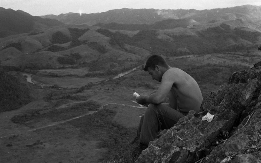 An unknown Marine reads to pass the time while stationed at the Rockpile in November 1966. The Rockpile was a gigantic rock formation in Vietnam that was of some strategic importance and the site of an entrenched American presence in 1966. 