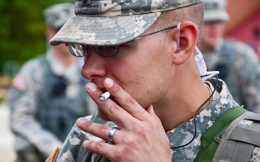 A U.S. soldier smokes a cigarette during a Kosovo Forces training exercise at the Joint Multinational Readiness Center in Hohenfels, Germany, Aug. 25, 2012.
