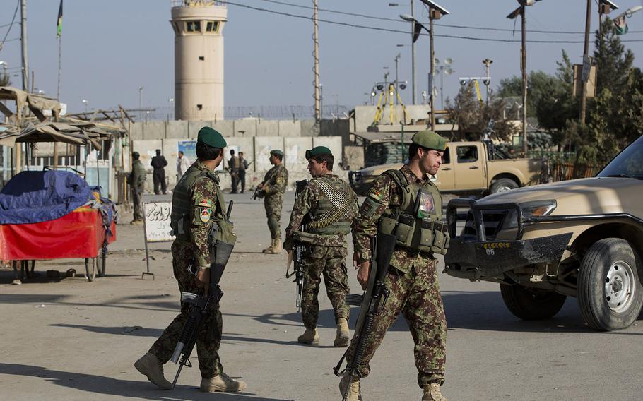 Afghan National Army soldiers guard, blocking the main road to the Bagram Airfield's main gate in Bagram, north of Kabul, Afghanistan, Saturday, Nov. 12, 2016.