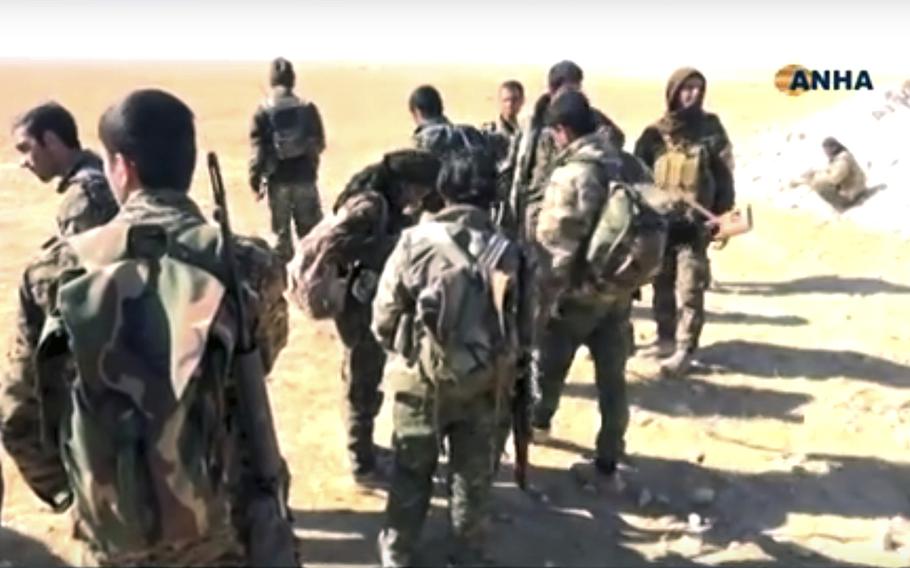 This frame grab from video provided on Monday, Nov. 7, 2016, by the Hawar News Agency, shows U.S.-backed fighters deployed during fighting with the Islamic State group in the village of Laqtah, north of Raqqa, Syria. Turkey said Tuesday that Washington has promised that U.S.-backed Syrian Kurdish forces will only be involved in encircling the Islamic State stronghold of Raqqa and will not enter the city itself. 