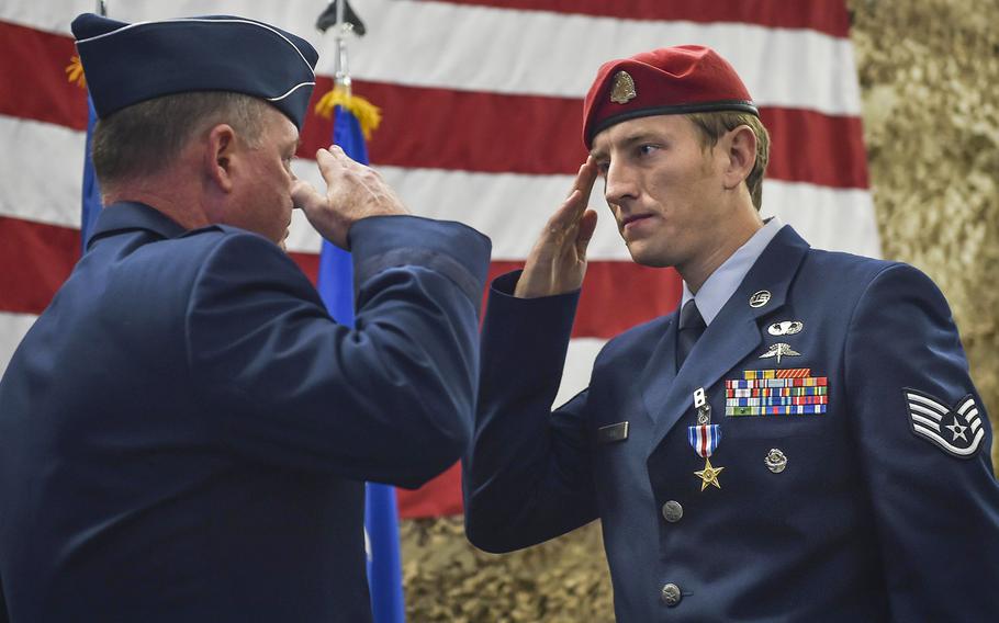 Staff Sgt. Keaton Thiem, a combat controller and Silver Star Medal recipient with the 22nd Special Tactics Squadron, salutes Maj. Gen. Eugene Haase, vice commander of Air Force Special Operations Command, during a Silver Star Medal presentation ceremony at Joint Base Lewis-McChord, Wash., Nov. 16, 2016.
