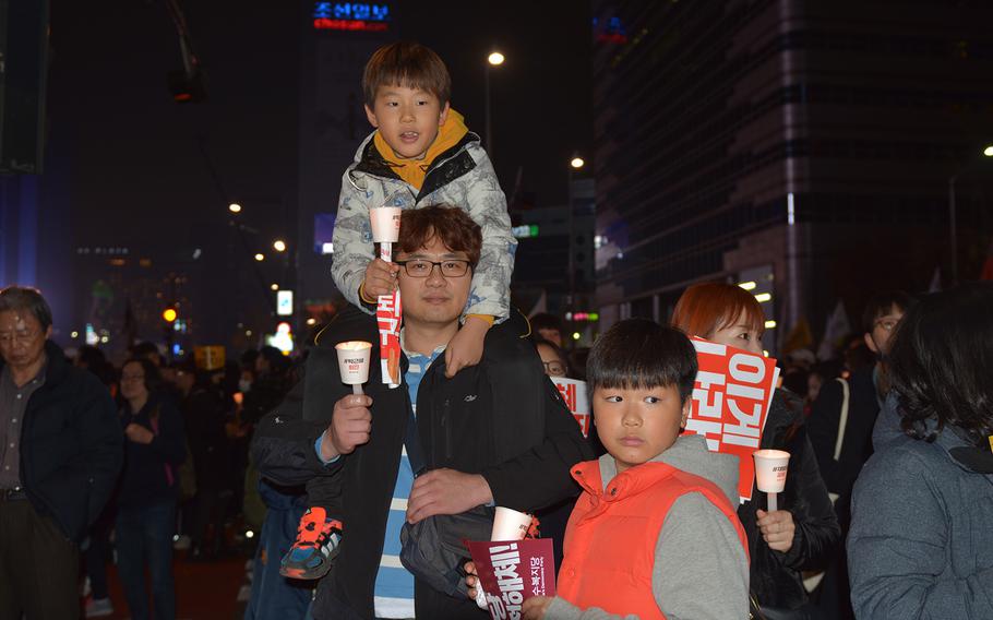 Hundreds of thousands of South Koreans fill the historic Gwanghamun Square and surrounding streets in Seoul on Saturday, Nov. 19, for the fourth week in a row. Many brought their children as they calling on President Park Geun-hye to resign over an influence peddling and corruption scandal involving a close friend.