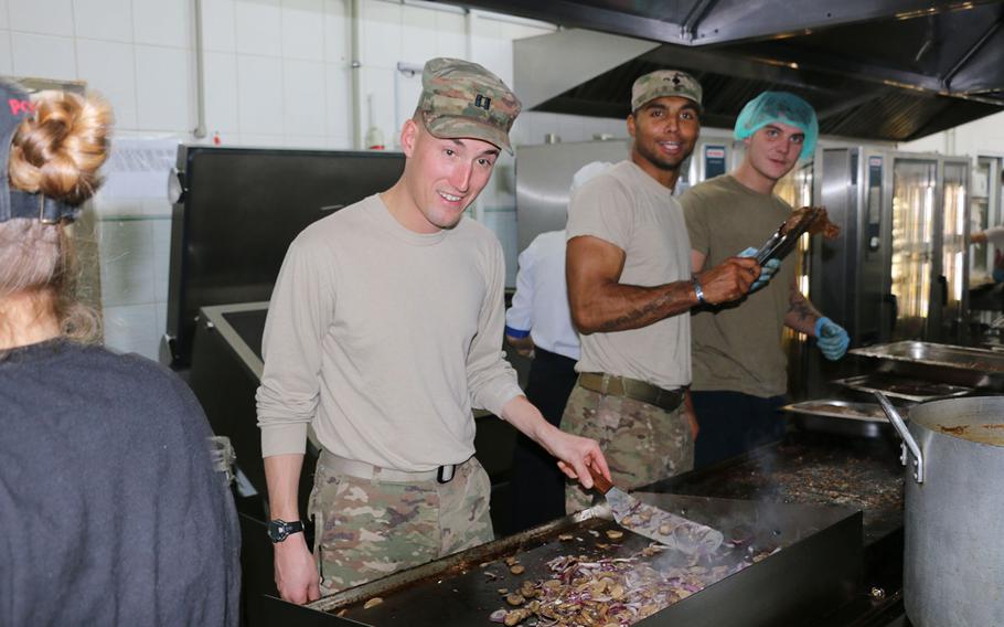 Capt. Andrew Hibbs, commander of Troop B, 6th Squadron, 8th Cavalry Regiment, 2nd Infantry Brigade Combat Team, 3rd Infantry Division grills shrimp and onions during Thanksgiving food preparation in Yavoriv, Ukraine on Nov. 24, 2016. 