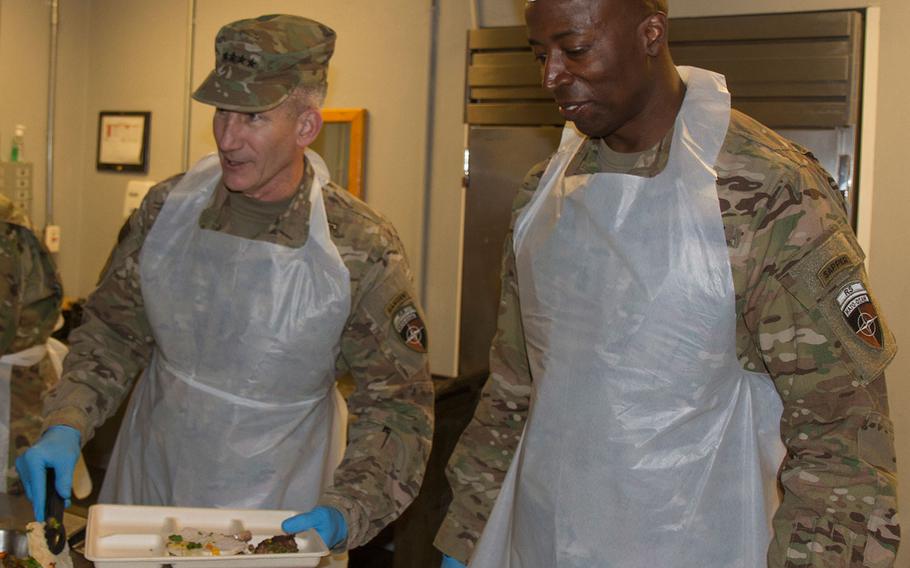 Gen. John Nicholson, commander of Resolute Support Mission and U.S. Forces Afghanistan, and Command Sgt. Maj. David M. Clark serve Thanksgiving lunch to coalition forces and U.S. Army civilians at Bagram Airfield, Afghanistan on Nov. 24, 2016.