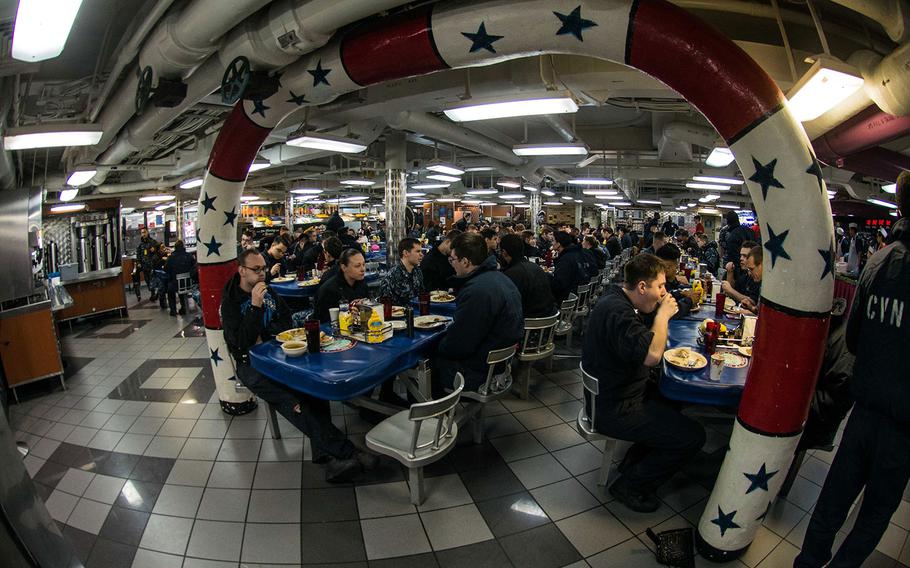 Sailors enjoy a Thanksgiving meal on Nov. 24, 2016 with shipmates and family members on the USS Ronald Reagan in Yokosuka, Japan.