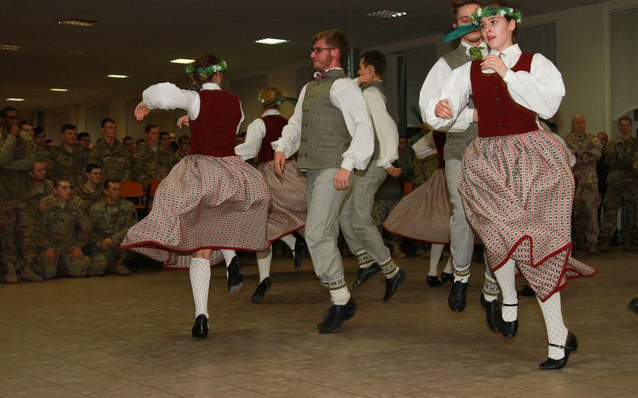 Traditional Latvian folk dancers perform for U.S. paratroopers of the 2nd Battalion, 503rd Infantry Regiment, 173rd Airborne Brigade, and the Latvian Land Forces Infantry Brigade, before sharing Thanksgiving dinner at Camp Adazi, Latvia, Nov. 22, 2016. 