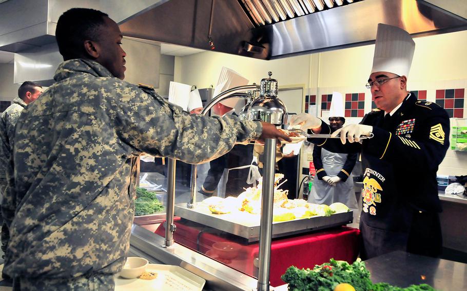 On Nov. 22, 2016, 1st. Sgt. Daniel Salinas of the 226th Signal Company serves up a slice of turkey to a 10th Mountain Division Sustainment Brigade soldier during the brigade's Thanksgiving celebration at Fort Drum in New York.