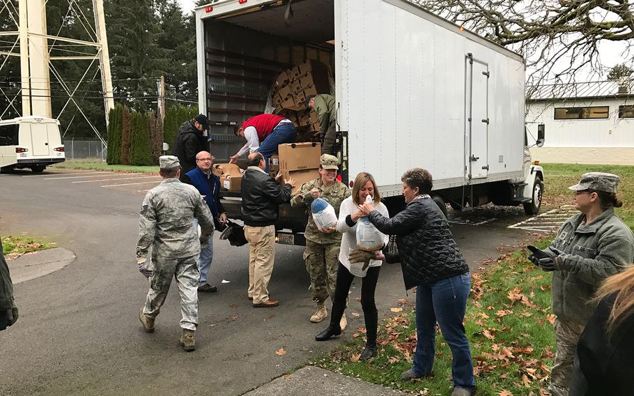 Volunteers and airmen from the 446th Airlift Wing's Airmen and Family Readiness Center help unload turkeys from a truck as part of the annual Turkey drop on the Rainier Wing on Nov. 18, 2016. The Puget Sound Business Alliance partnered with the AFRC to donate 83 turkeys as part of an ongoing effort to provide airmen in need with a Thanksgiving meal.