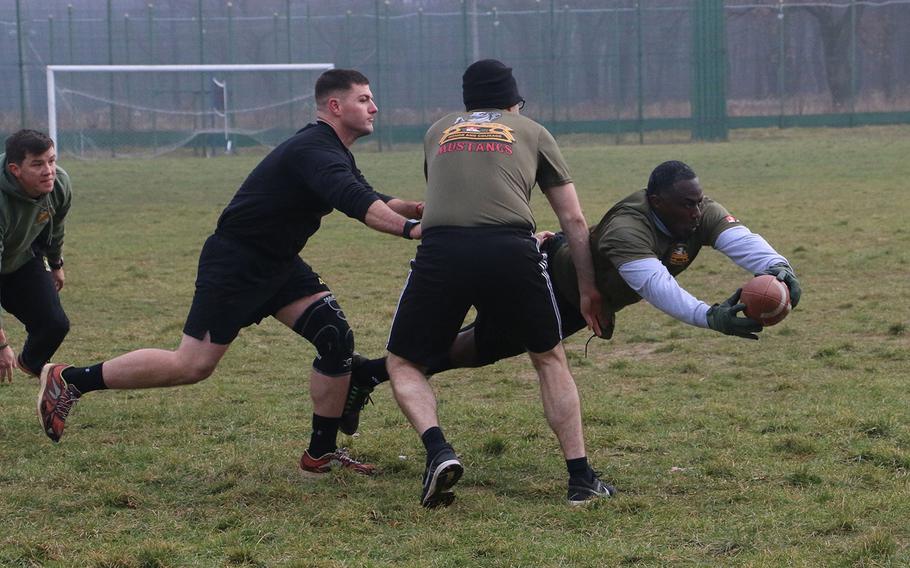 Sgt. 1st. Class. Antron Myers with the 6th Squadron, 8th Cavalry Regiment, 2nd Infantry Brigade Combat Team, 3rd Infantry Division dives into the end zone to score a touchdown during a Thanksgiving football tournament in Yavoriv, Ukraine on Nov. 24, 2016.