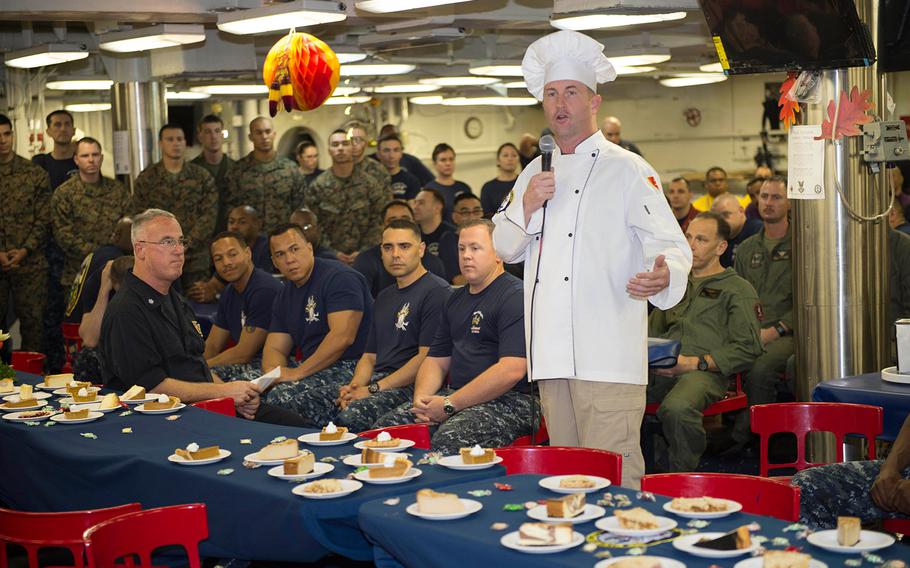 Capt. Mark Melson, commanding officer of the amphibious assault ship USS Makin Island addresses sailors and Marines before Thanksgiving Day dinner on the ship's mess decks in the Indian Ocean.  The Makin Island, with the embarked 11th Marine Expeditionary Unit, celebrated Thanksgiving while underway in the U.S. 7th Fleet area of operations.