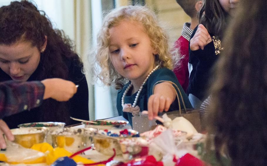 A girl grabs a candy cane at the White House on Nov. 29, 2016. First Lady Michelle Obama invited military families to the White House to preview holiday decorations.