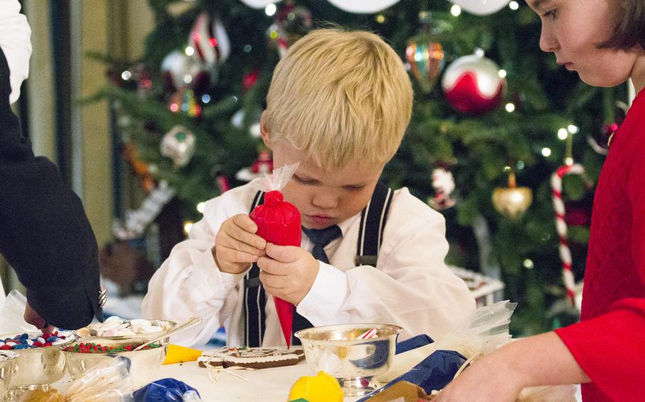 A boy decorates a cookie at the White House on Nov. 29, 2016. First Lady Michelle Obama invited military families to the White House to preview holiday decorations.