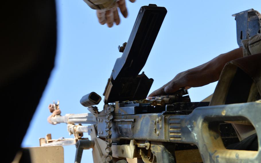 An Iraqi soldier loads a PK machine gun in the turret of an Iraqi army Humvee near Mosul, Nov. 19, 2016. Amnesty International found that Iraqi army weapons supplied by the U.S., Russia and other countries have wound up in the hands of Iran-backed Shiite militias accused of committing war crimes.




