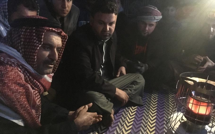 A man who identified himself only as Mohammed, left, pictured here at a camp for displaced Iraqis near Qayara on Dec. 14, 2016, said two of his brothers had been abducted by militias participating in the campaign to liberate Mosul. 
