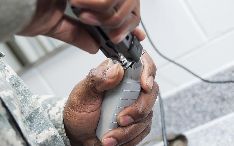 Army Sgt. Jhamon Grant prepares to cut hair at Joint Base McGuire-Dix-Lakehurst, N.J. Female soldiers can now wear their hair in dreadlocks, Army Secretary Eric Fanning announced this week alongside several other changes to the service’s appearance standards.