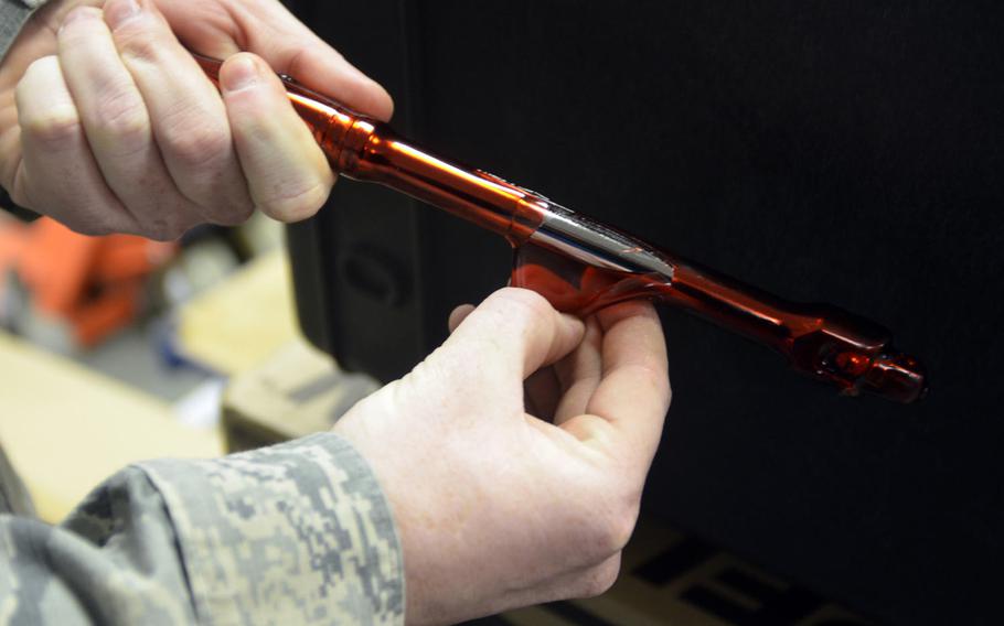 Staff Sgt. Ryan St. John, 100th Maintenance Squadron noncommissioned officer in charge of the isochronal inspection support section, peels a protective plastic coating from a spare tool in his shop at RAF Mildenhall, England, Tuesday, Jan. 10, 2017. The plastic coating gives the tools impact protection and prevents corrosion by eliminating exposure to air.
