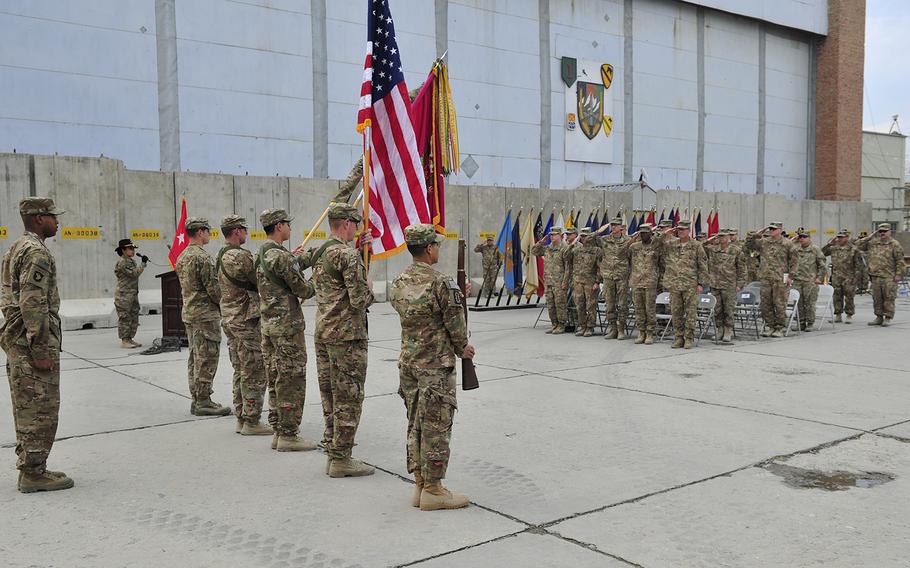 Soldiers render honors to the flag during the playing of the national anthem at the transfer of authority ceremony between the 63rd Ordnance Battalion and the 184th Ordnance Battalion at Bagram Air Field in Afghanistan on Nov. 29, 2016. Two days after President Donald Trump took office, the Taliban asked him to remove all U.S. troops from Afghanistan but hinted at a willingness to work with the United States.