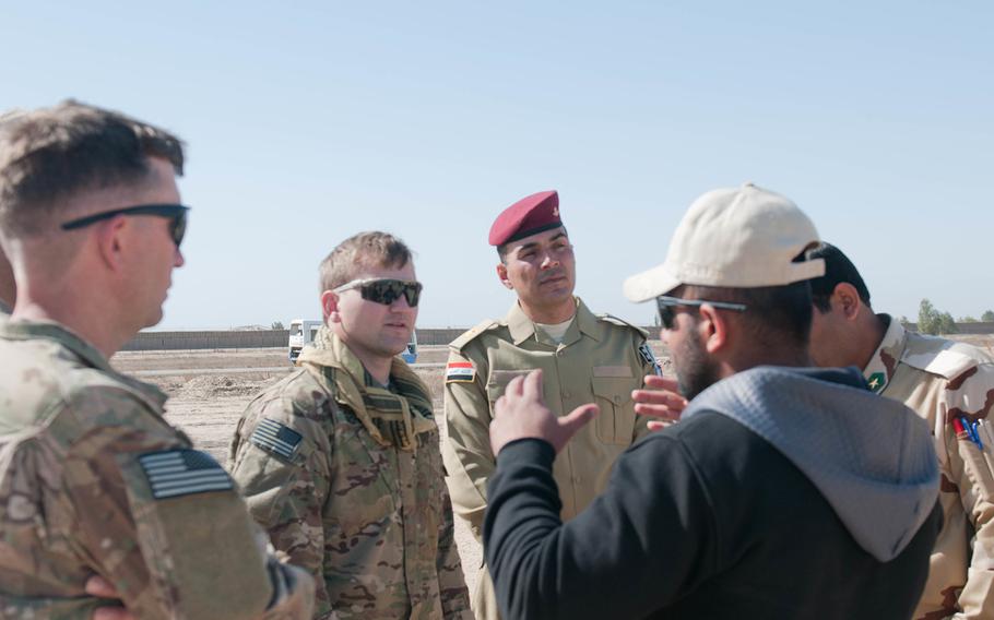 An interpreter translates for U.S. and Iraqi EOD teams while they observe a field test March 2, 2007, at Besmaya Range Complex, Iraq. 