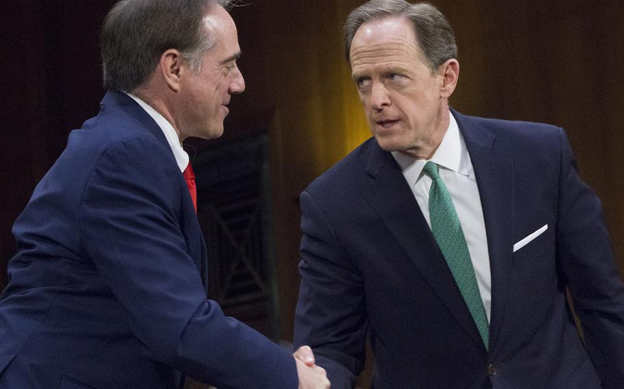 Sen. Pat Toomey, R-Pa., right, shakes hands with Secretary of Veterans Affairs nominee Dr. David Shulkin after introducing Shulkin at a Senate Committee on Veterans' Affairs confirmation hearing on Capitol Hill, Feb. 1, 2017