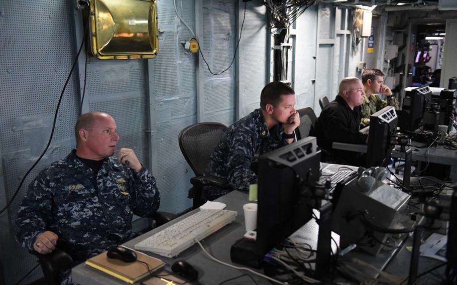 Cmdr. Robert Round, a senior Navy meteorology and oceanography officer, works alongside his team during U.S. European Command's computer-assisted exercise, Austere Challenge 17, aboard the USS Mount Whitney on Oct. 11, 2016.