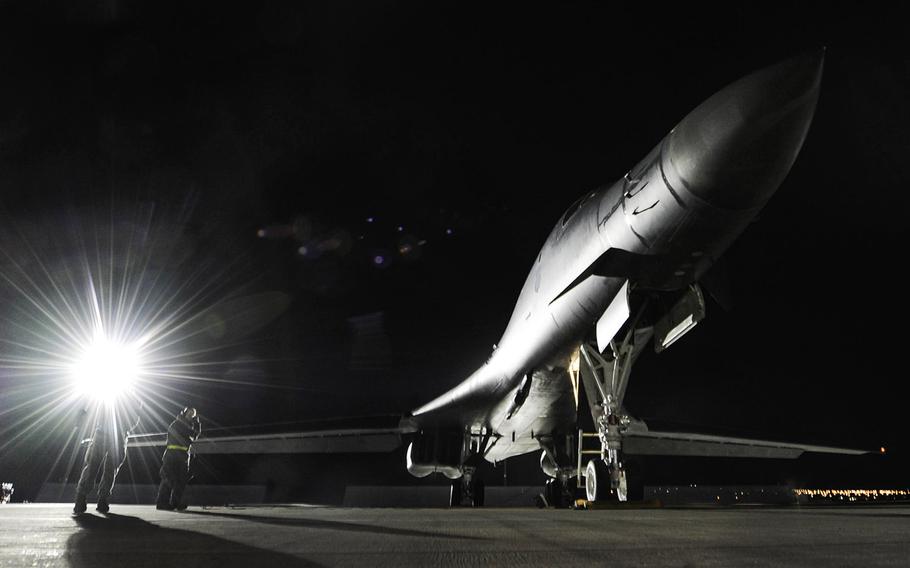 A B-1B Lancer assigned to the 34th Bomb Squadron, Ellsworth Air Force Base, S.D., rests on the flightline as maintainers perform preflight checks during night operations of Red Flag 17-1 on Nellis Air Force Base, Jan. 25, 2017.