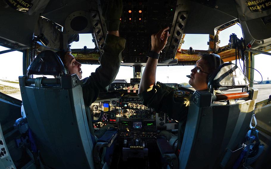 U.S. Air Force Capt. Scott Carlan, left, and Capt. Jack Ryan, 351st Expeditionary Air Refueling Squadron KC-135 Stratotanker pilots, prepare to depart Istres-Le Tube Air Base, France, Feb. 26, 2016. 