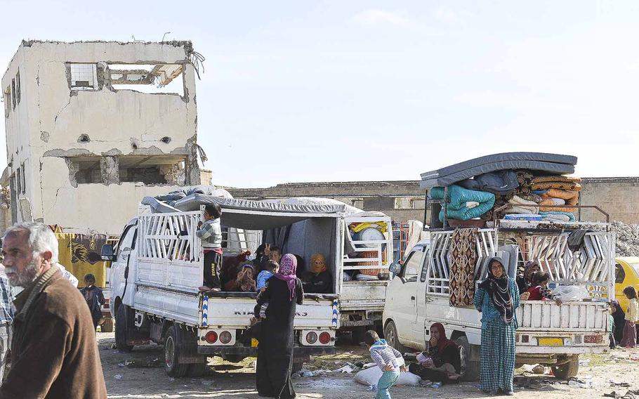 Families fleeing the battle for Mosul wait in trucks outside a camp for displaced Iraqis south of the city on Thursday, March 9, 2017. Thousands of civilians were staying in the camp, but many families were being screened for ties to the Islamic State group before being allowed to flee further from the city.

