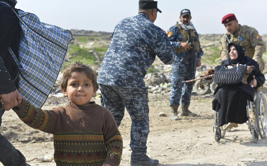 This boy, pictured on Wednesday, March 8, 2017, flees Mosul with his family, as Iraqi security forces assist an elderly woman in a wheel chair. Thousands of Iraqis are escaping the city, taking what they can carry, as Iraqi forces fight to retake it from the Islamic State, which has held it since summer 2014.


