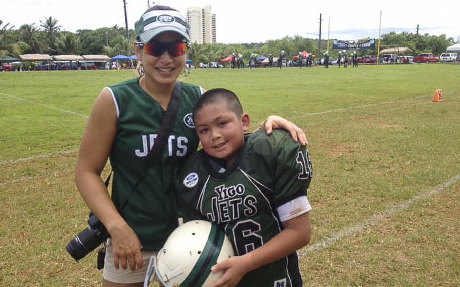 Gail Martinez and her son Kimo after a football game in Guam in 2012.