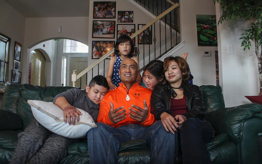 Air Force Lt. Col. Kato Martinez sits with his four children at their home in San Antonio, Texas, on Feb. 14, 2017. The Martinez family is readjusting to life without Gail Martinez, mother and wife, who was killed in the Brussels Airport bombing on March 22, 2016. The attack seriously injured Martinez and his four children.