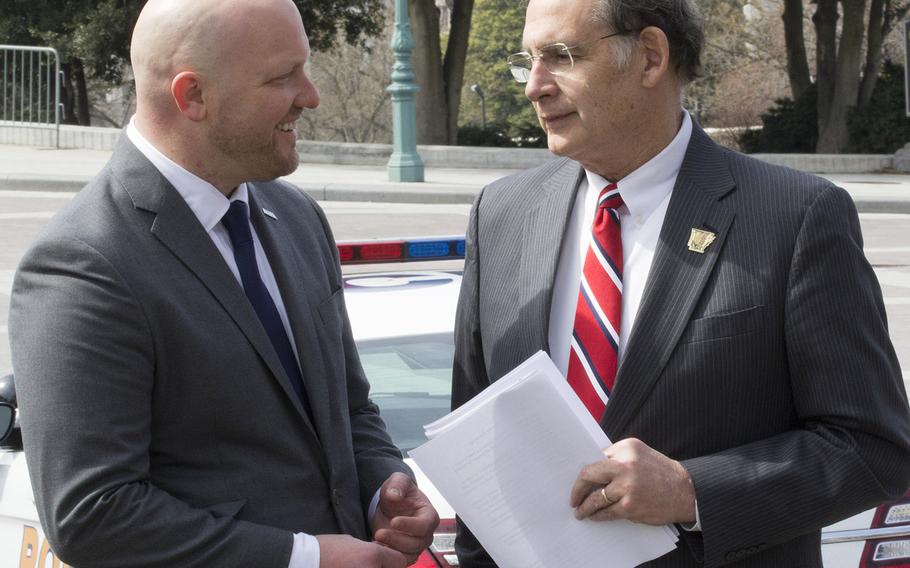 Iraq And Afghanistan Veterans Of America IAVA founder and CEO Paul Rieckhoff, left, talks with Sen. John Boozman, R-Ark., before a Capitol Hill press conference on March 21, 2017.