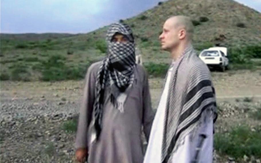 A video screen grab shows Sgt. Bowe Bergdahl, right, standing with a Taliban fighter in eastern Afghanistan. 