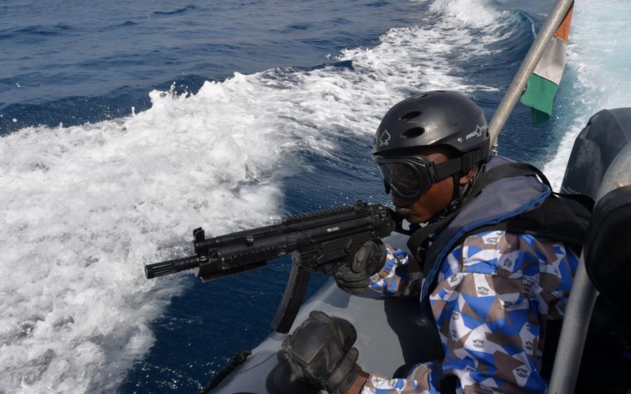 A member of the Ivorian Maritime Interdiction Operations team keeps watch as part of a simulated anti-narcotics search-and-seizure raid during Obangame Express on March 27, 2017. 