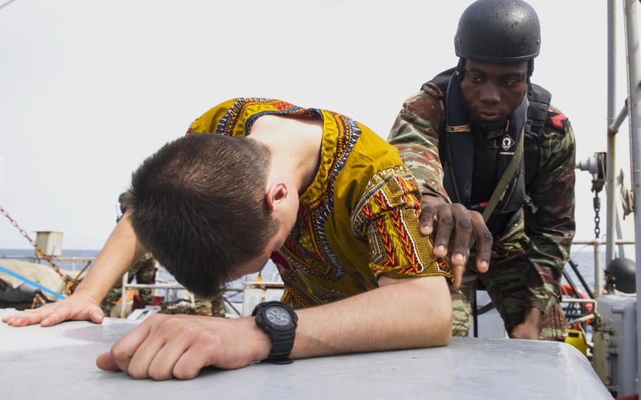 Benin sailor Gamavo Weely searches a French sailor in a practice raid on the French frigate E.V. Jacoubet March 26, 2017 during Obangame Express, a 12-day exercise that U.S. Africa Command hosted to improve West African nations' policing of their waters. 
