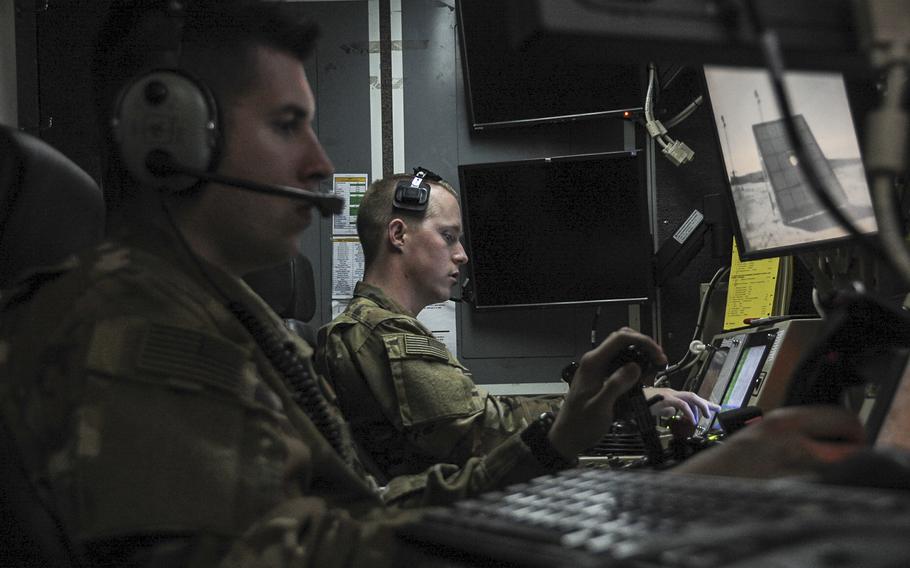 Senior Airman James, left, 46th Expeditionary Attack Squadron sensor operator, and 1st Lt. Matthew, 46th EAS pilot, sit inside a ground station control at an undisclosed location in Southwest Asia, Feb. 14, 2017. The 46th EAS Airmen conduct launch and recoveries of MQ-1 Predator remotely piloted aircraft in support of the coalition to defeat the Islamic State in Iraq and Syria. 