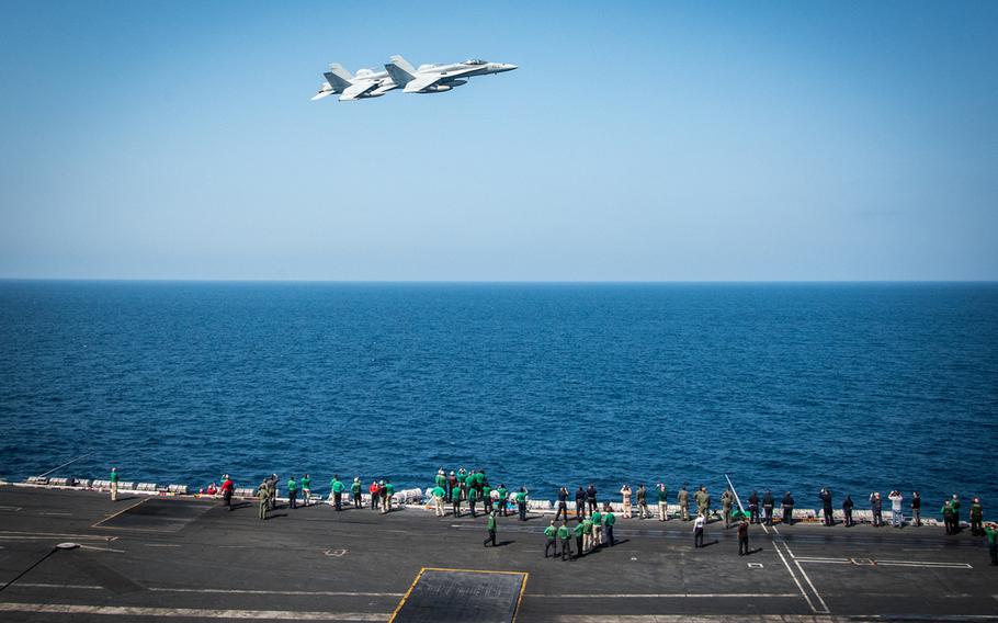 Two F/A-18C Hornets fly about the above the Carl Vinson Carrier Strike Group in the South China Sea on March 5, 2017. 