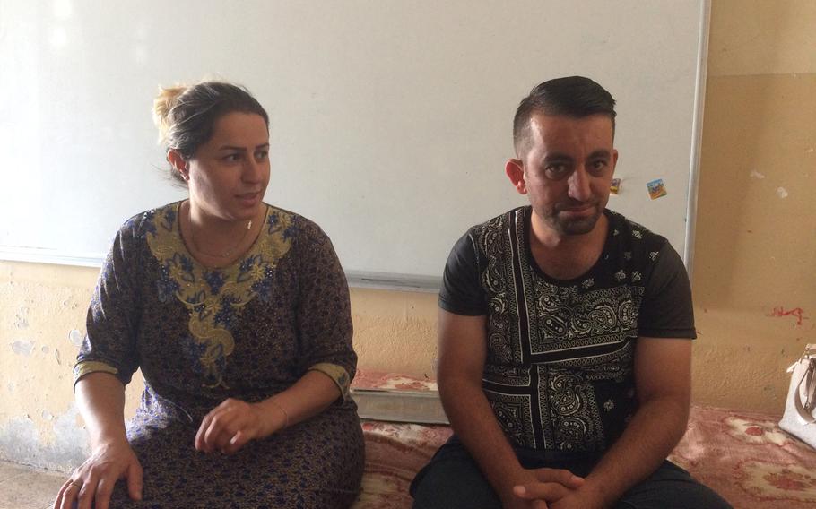 Yazidi couple Hazna Hassan, 35, left, and Firas Alyas, 40, talk about living in a camp for displaced people in Irbil, Iraq, for three years. They are preparing to return home following the liberation of their town from the Islamic State.
