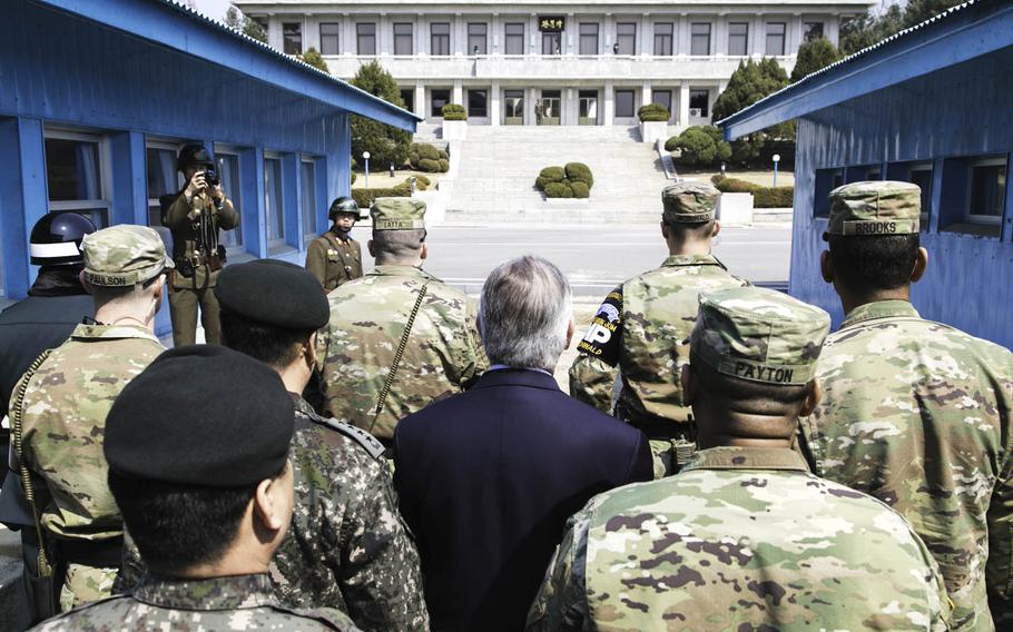 Secretary of State Rex Tillerson, center, stands with U.S. Forces Korea Commander Gen. Vincent Brooks, far right, and other military officials at the Joint Security Area of the Demilitarized Zone that divides North and South Korea, March 17, 2017.