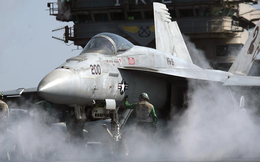 In an October, 2016 file photo, an F/A-18E Super Hornet undergoes preflight checks prior to launching from the flight deck of the aircraft carrier USS Dwight D. Eisenhower in the Persian Gulf.