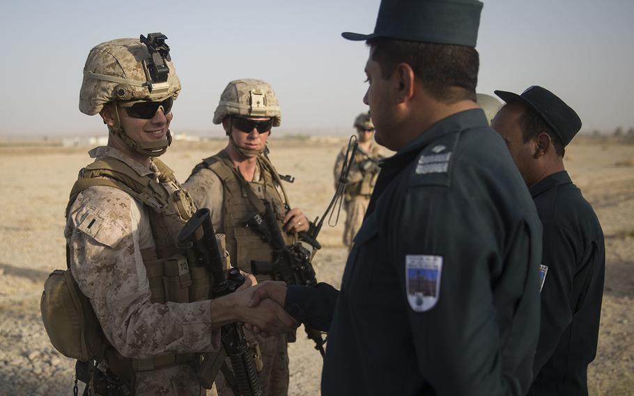 A U.S. Marine advisor with Task Force Southwest thanks an Afghan National Policemen for showing them around and introducing them to the ANP security guards at Bost Airfield, Afghanistan, July 31, 2017.  