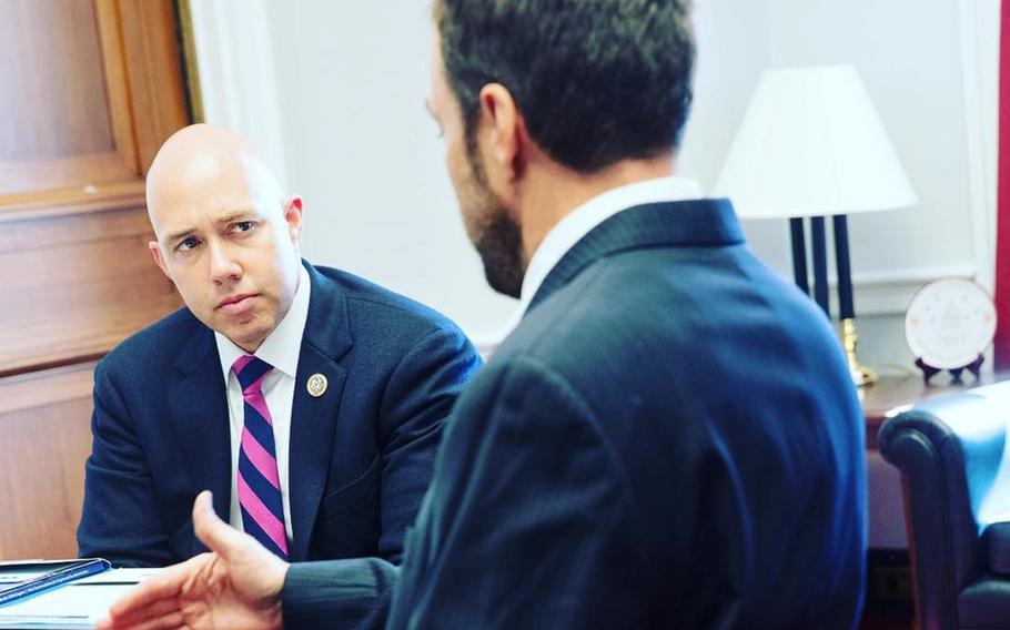 Rep. Brian Mast, R-Fla., speaks with a representative of the Paralyzed Veterans of America on March 8, 2017. Mast, a wounded Army vet, is championing an idea that would ask servicemembers leaving active duty to sign an oath not to harm themselves. 