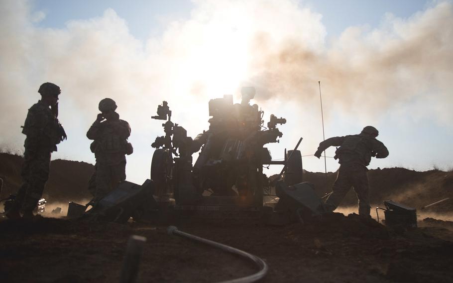 U.S. soldiers assigned to Battery C, 2nd Battalion, 319th Airborne Field Artillery Regiment, 82nd Airborne Division fire their M777 towed 155 mm howitzer during a fire mission near Mosul, Iraq, Feb. 03, 2017.  