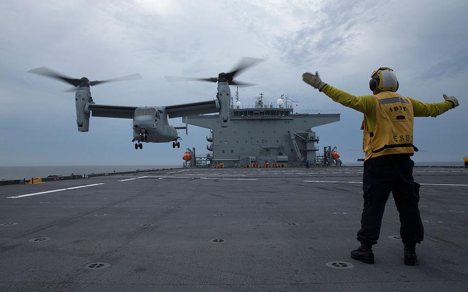 A sailor assigned  to the USNS Lewis B. Puller, gives the handling signal to conduct a vertical takeoff to Marines assigned to Marine Medium Tiltrotor Squadron (VMM) 263, aboard the USNS Lewis B. Puller, July 5, 2017. 